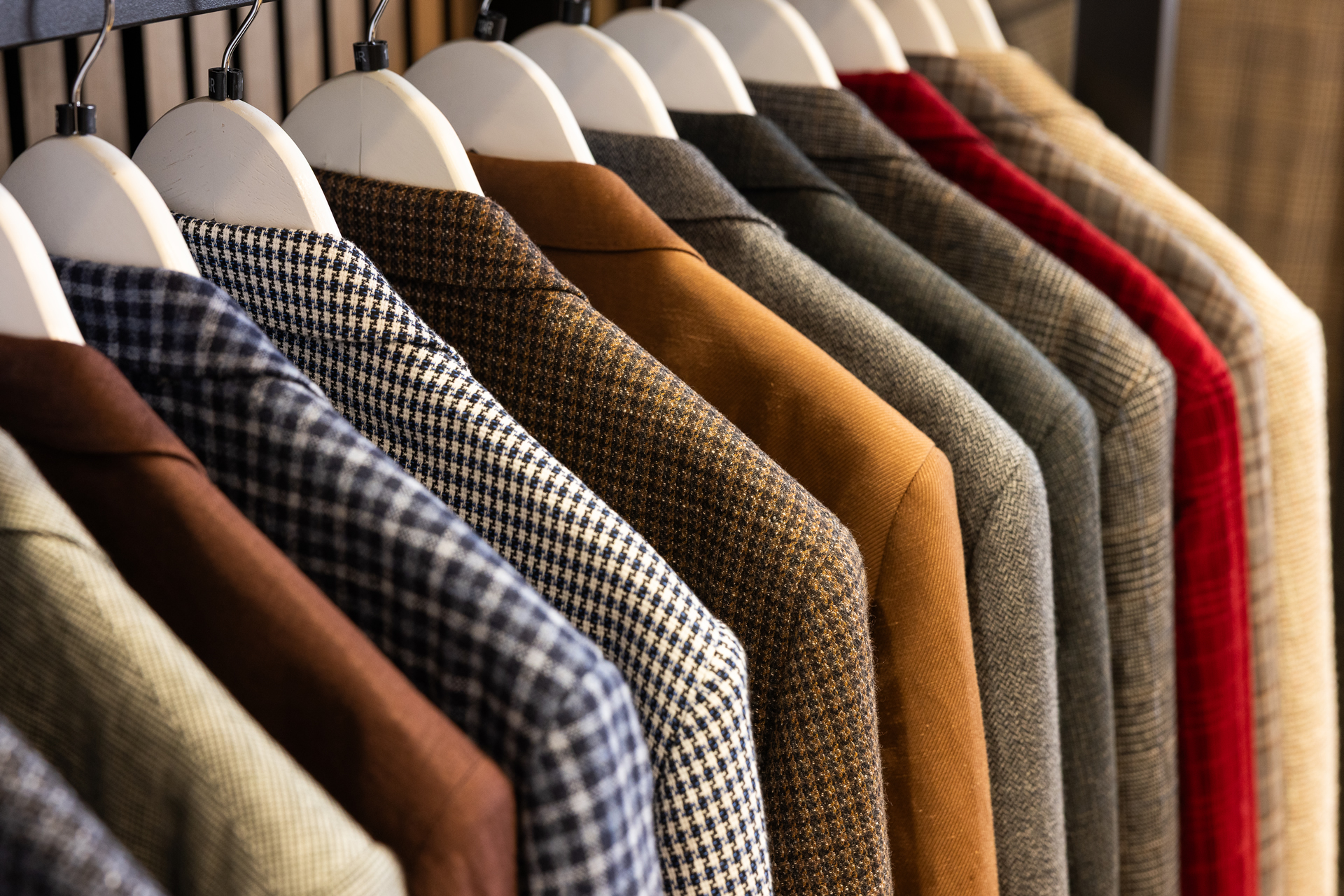 A rack of tweed and wool sport jackets in a range of checks and colours