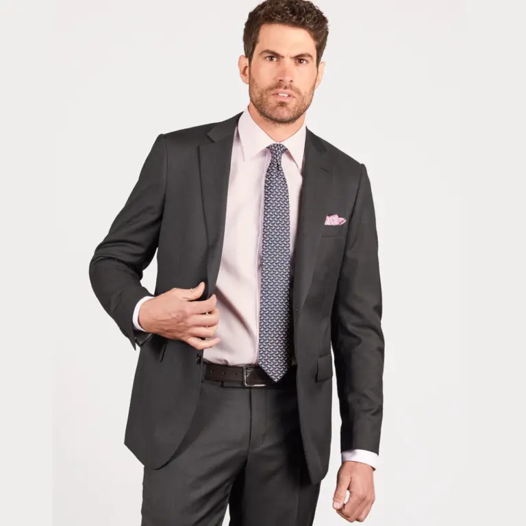 Man wearing a charcoal two piece suit with a pink shirt and patterned tie