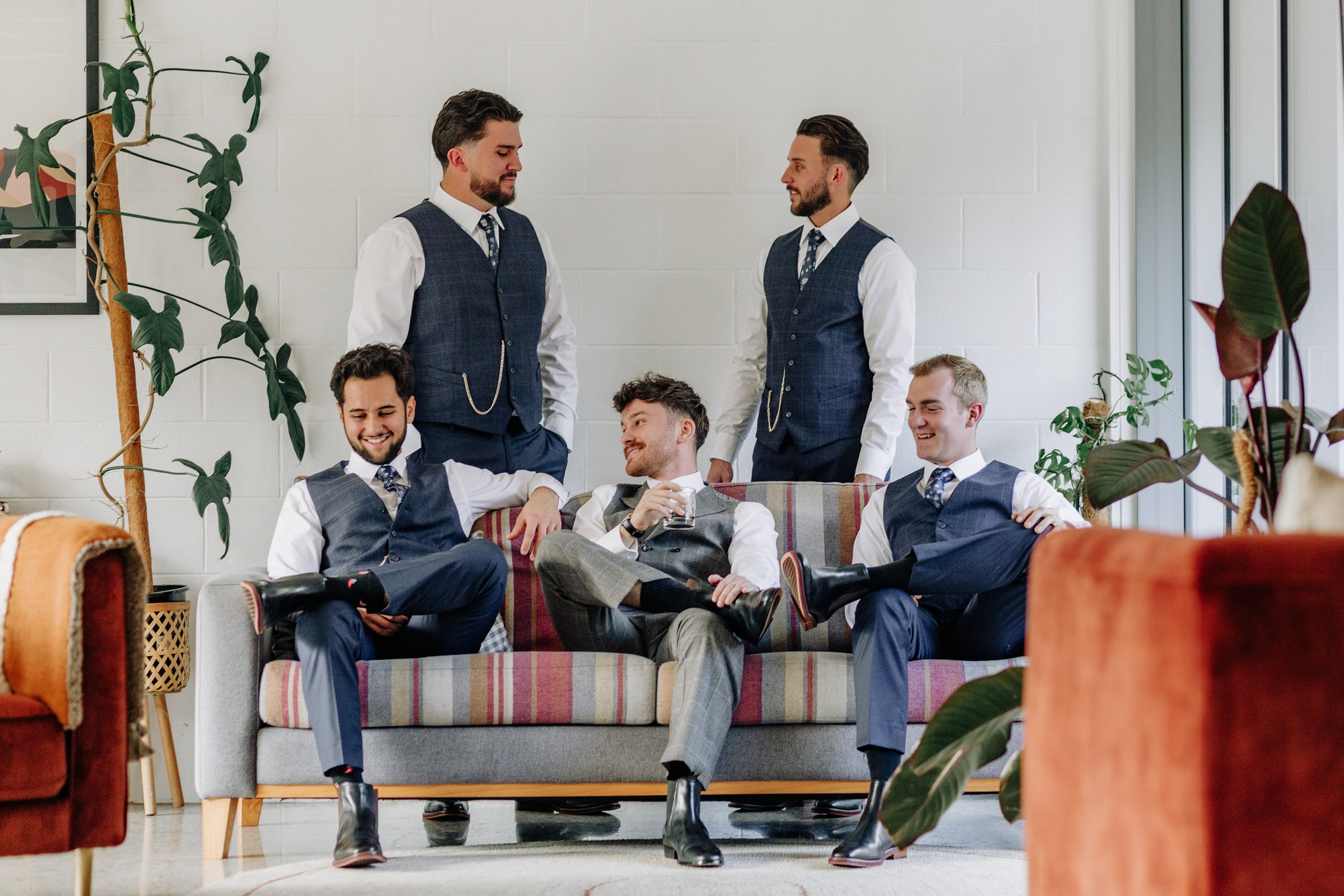 Groom and groomsmen in tailored suits ahead of a wedding